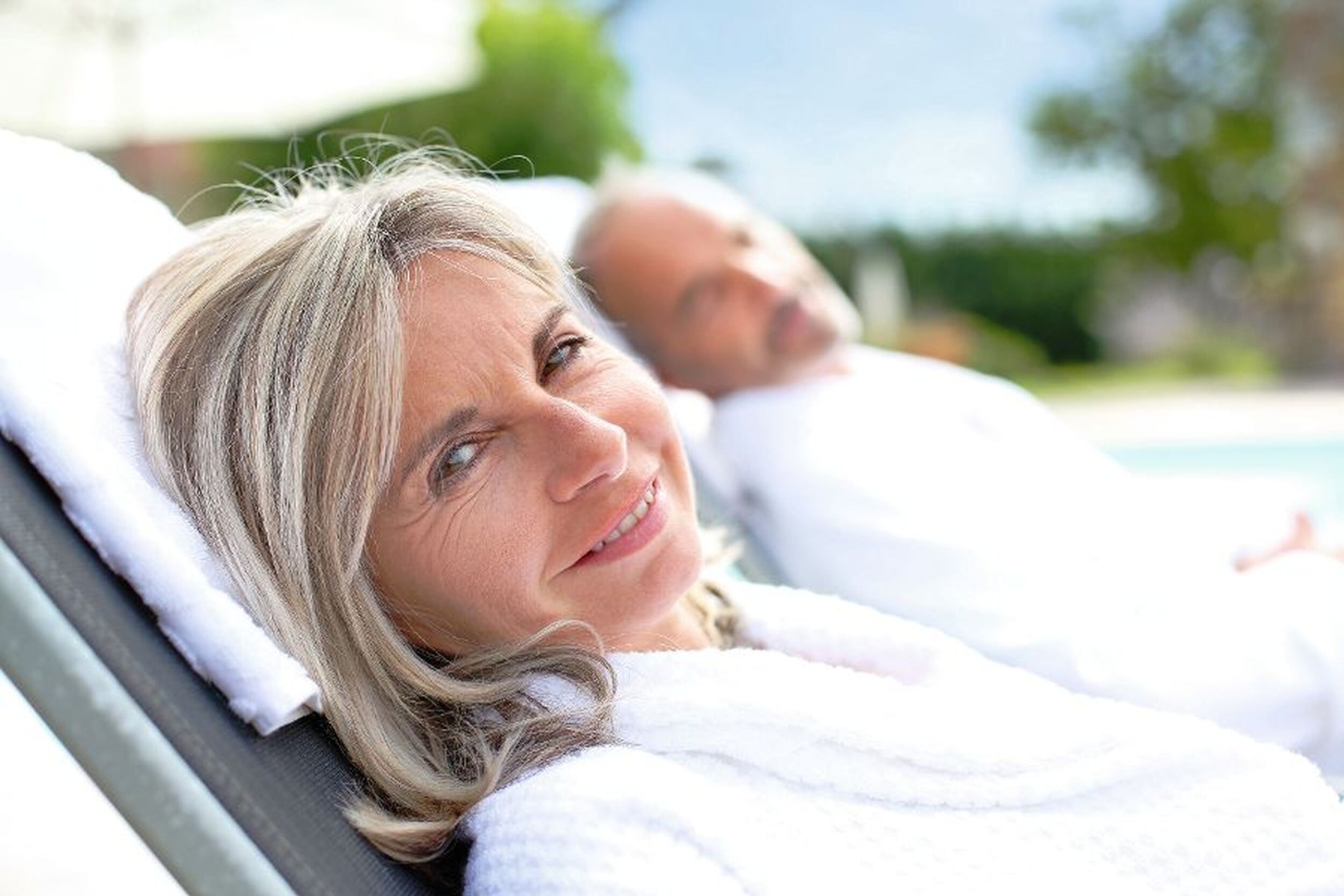 Senior woman in spa hotel relaxing by the pool